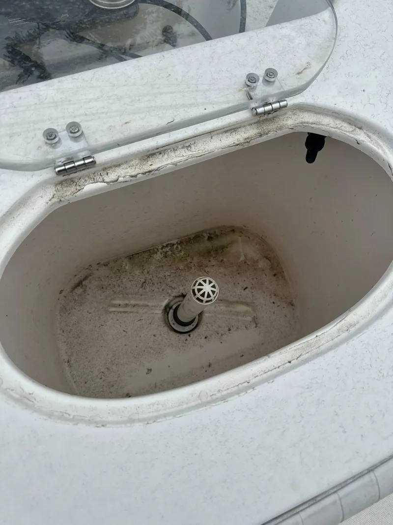 Slide: The Image of Open storage compartment on 2005 Sea Hunt Triton 232 boat. - 17