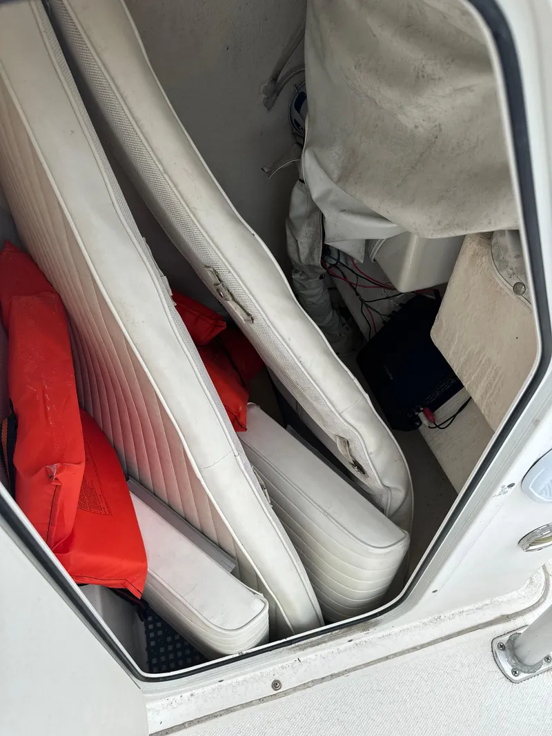 Slide: The Image of Interior of 2005 Sea Hunt Triton 232 with cushions and life jackets. - 20