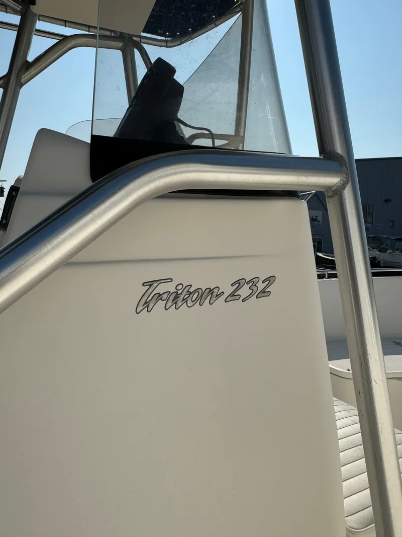Slide: The Image of 2005 Sea Hunt Triton 232 boat console with stainless steel railing. - 8