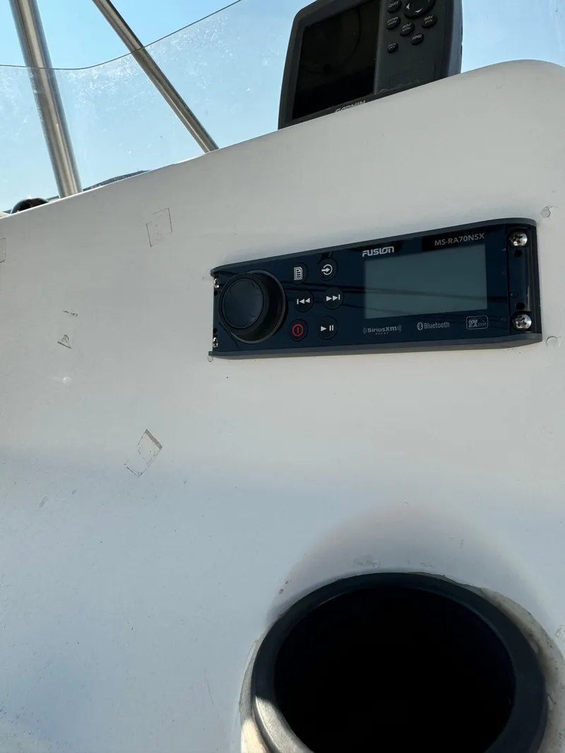 Slide: The Image of 2005 Sea Hunt Triton 232 boat dashboard with Fusion stereo system. - 9