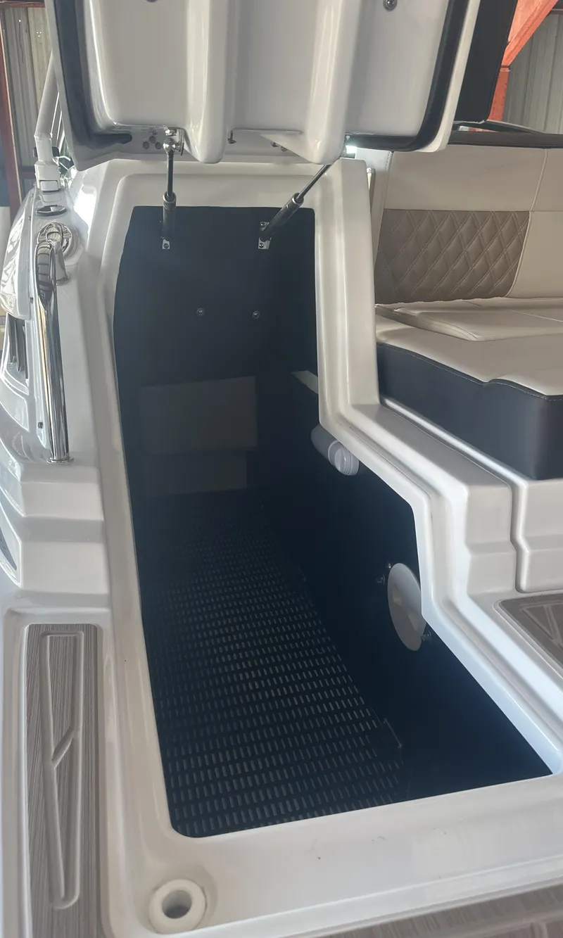 Slide: The Image of 2025 Monterey M45 boat storage compartment with open hatch and seating area. - 10