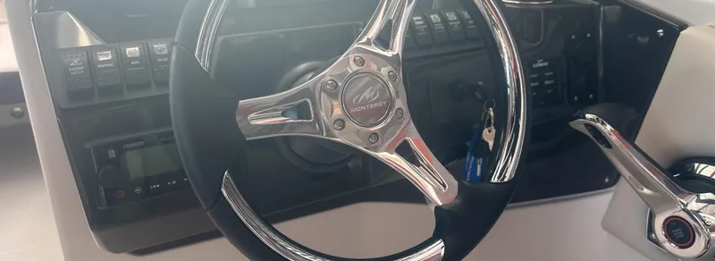 Slide: The Image of Steering wheel of 2025 Monterey M45 boat with control panel and throttle. - 22