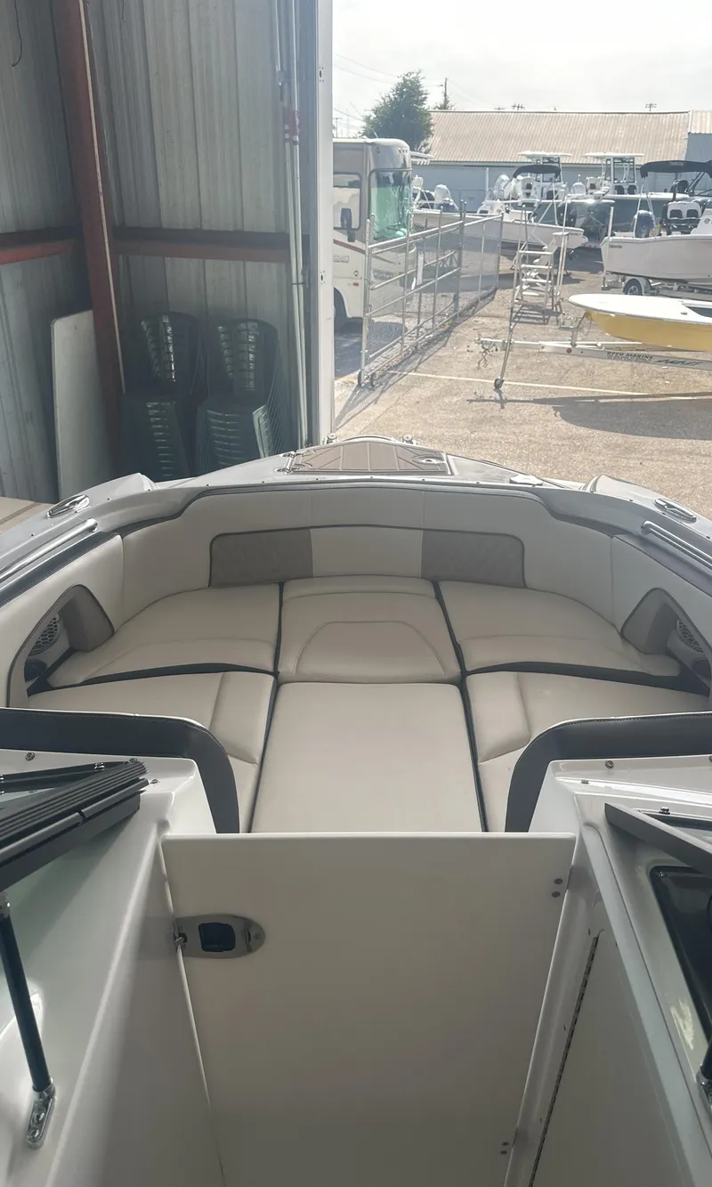 Slide: The Image of 2025 Monterey M45 boat interior with cushioned seating in a marina setting. - 33