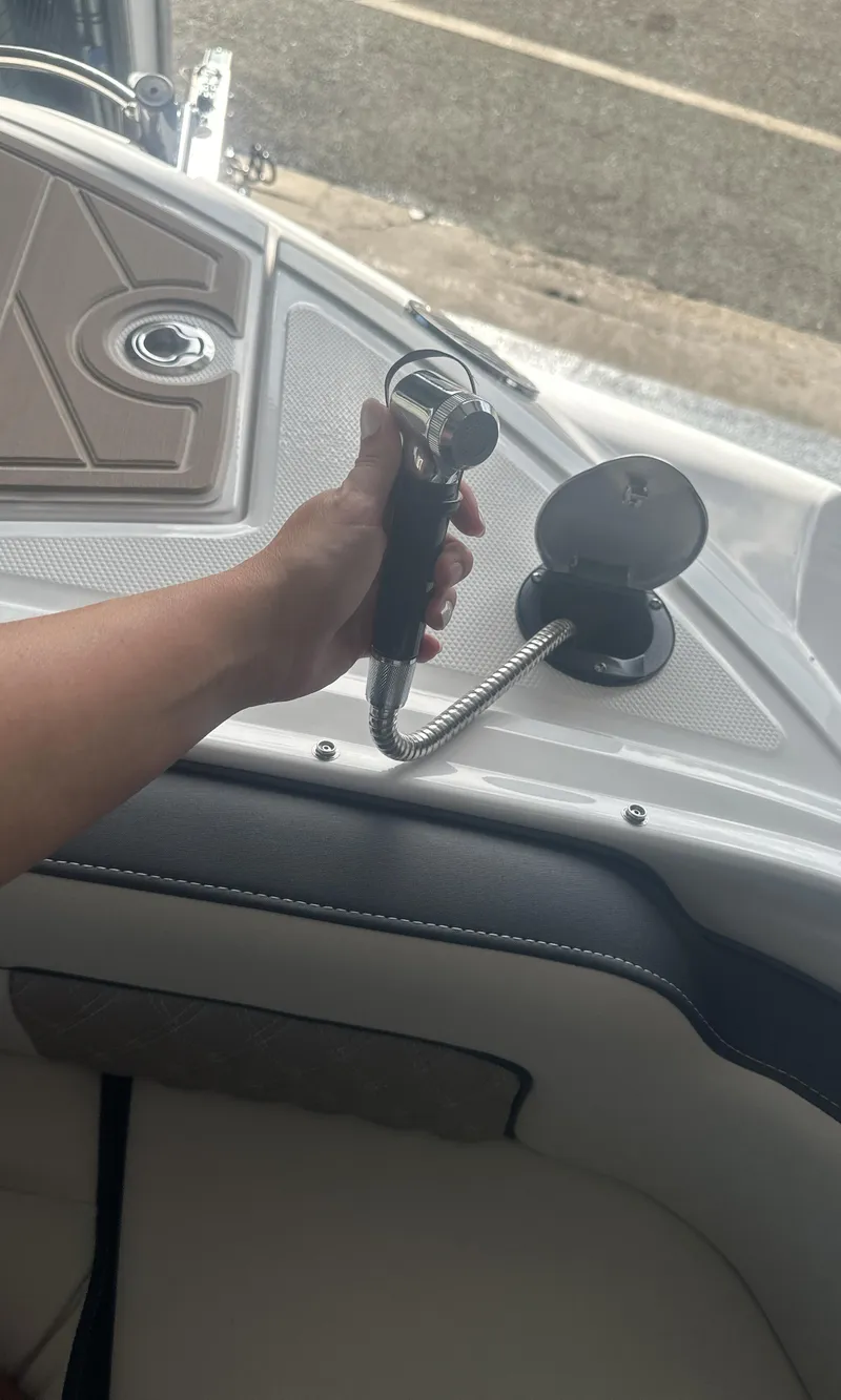 Slide: The Image of Hand holding a key on a 2025 Monterey M45 boat dashboard. - 35