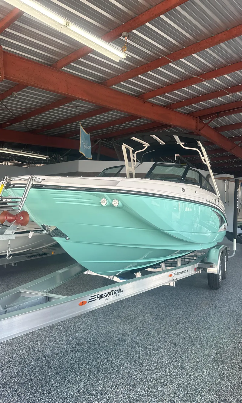 Slide: The Image of 2025 Monterey M45 boat in showroom, turquoise hull, on trailer. - 42