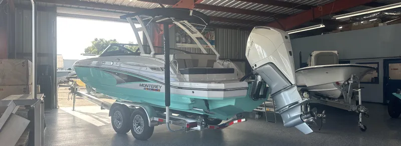 Slide: The Image of 2025 Monterey M45 boat in a garage, featuring a sleek design and powerful outboard motor. - 5