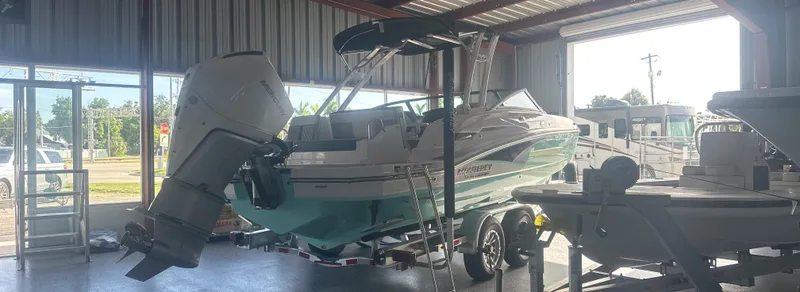 Slide: The Image of 2025 Monterey M45 boat in a showroom, featuring an outboard motor. - 6
