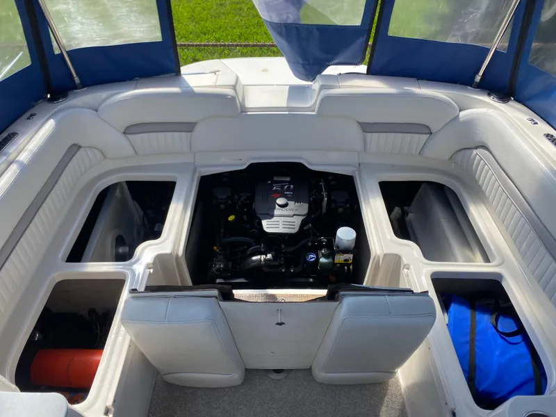 Slide: The Image of 2007 Stingray 22 DR boat interior with open engine compartment and storage areas. - 10