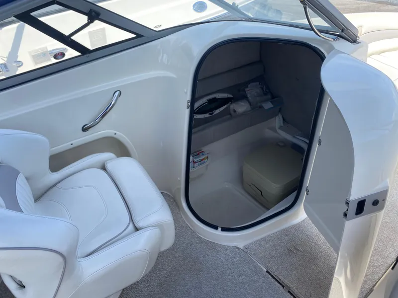 Slide: The Image of 2007 Stingray 22 DR boat interior with seating and storage compartment. - 11