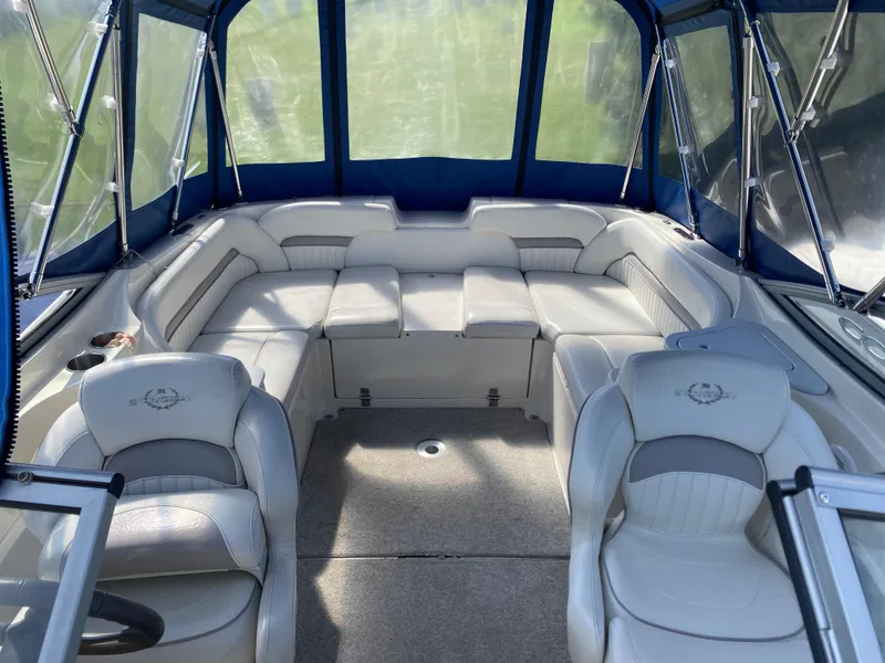 Slide: The Image of 2007 Stingray 22 DR boat interior with cushioned seating and blue canopy. - 7
