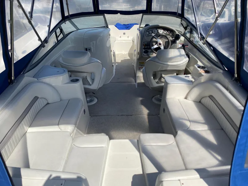 Slide: The Image of 2007 Stingray 22 DR boat interior with white seating and steering console. - 8