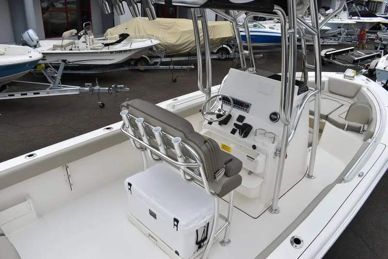 Slide: The Image of 2025 Key West 239 FS boat interior with helm, seating, and storage. - 10