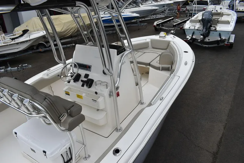Slide: The Image of 2025 Key West 239 FS boat with center console and seating, docked in a marina. - 12