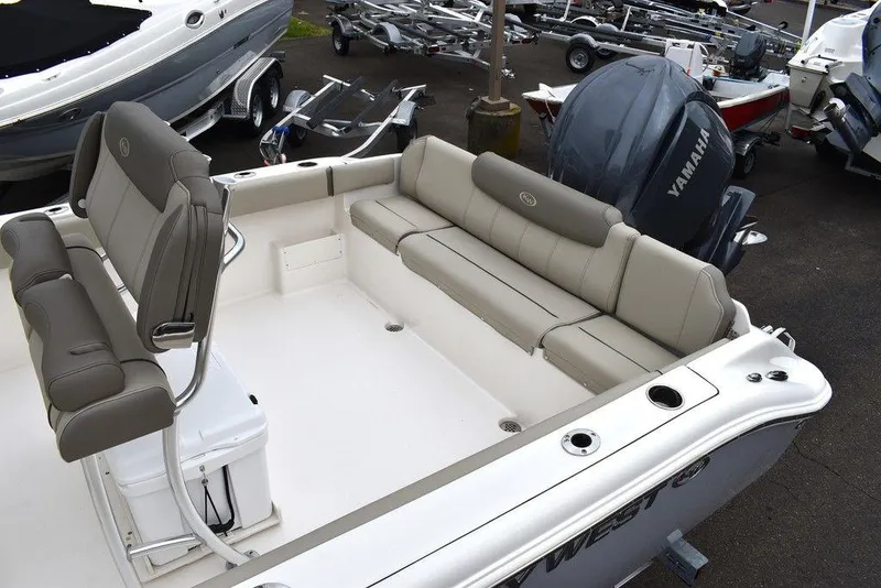 Slide: The Image of 2025 Key West 239 FS boat interior with cushioned seating and Yamaha engine. - 23