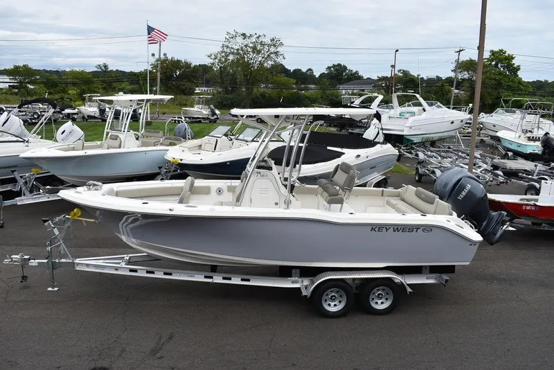 Slide: The Image of 2025 Key West 239 FS boat on trailer, surrounded by other boats, American flag in background. - 4