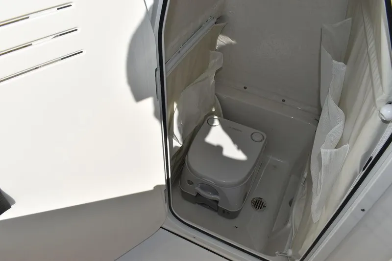 Slide: The Image of 2025 Key West 239 FS boat interior with portable toilet. - 43