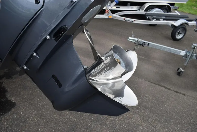 Slide: The Image of Key West 239 FS 2025 boat propeller and trailer on pavement. - 45