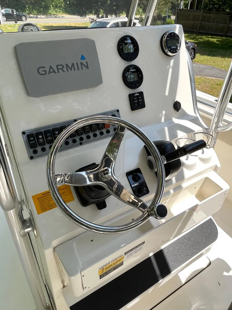 Slide: The Image of Key West 219 FS 2021 boat console with Garmin navigation and steering wheel. - 12
