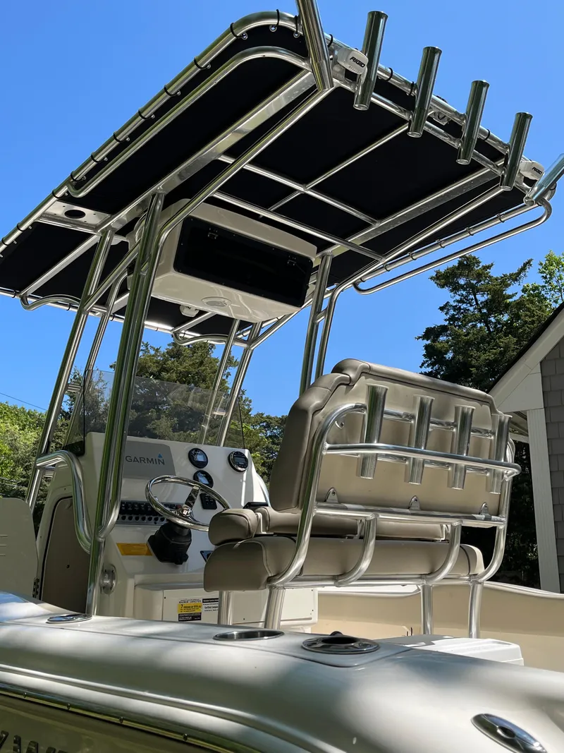 Slide: The Image of 2021 Key West 219 FS boat with T-top and helm station under clear blue sky. - 14