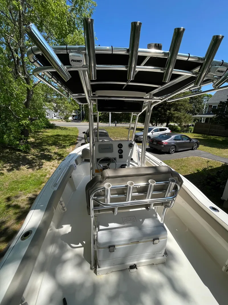 Slide: The Image of 2021 Key West 219 FS boat with T-top and console, parked outdoors. - 16