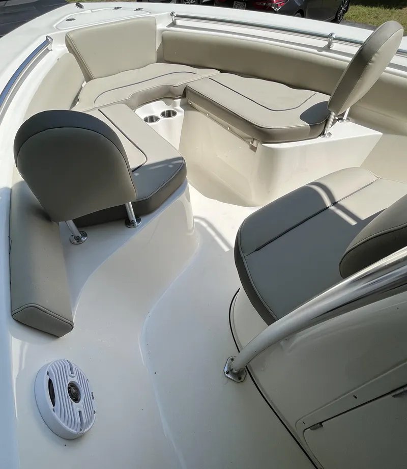 Slide: The Image of 2021 Key West 219 FS boat interior with cushioned seating and cup holders. - 17