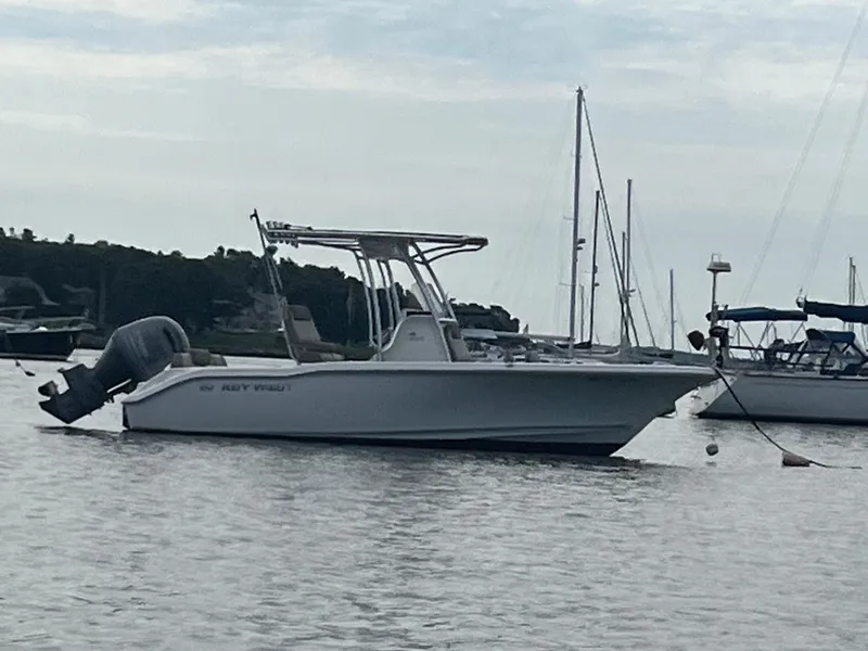Slide: The Image of 2021 Key West 219 FS boat anchored in a marina. - 2