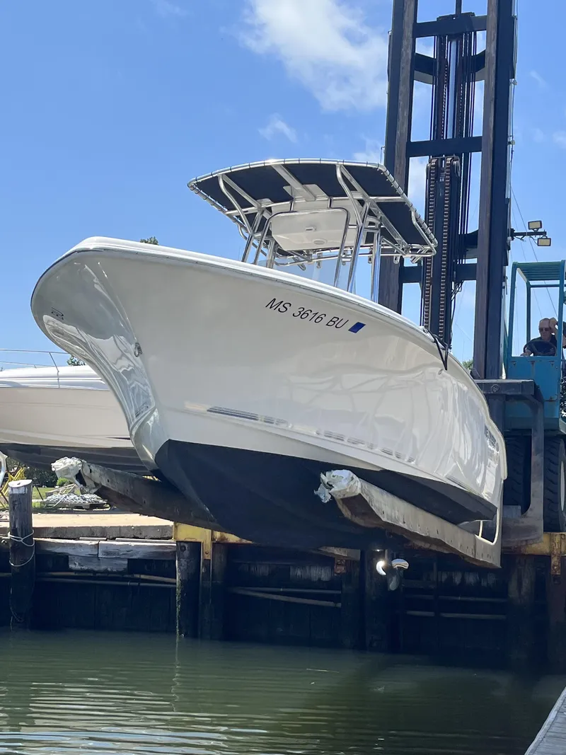 Slide: The Image of 2021 Key West 219 FS boat being lifted from water by a forklift. - 3