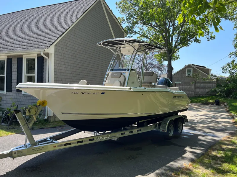 Slide: The Image of 2021 Key West 219 FS boat on trailer in driveway, sunny day. - 4