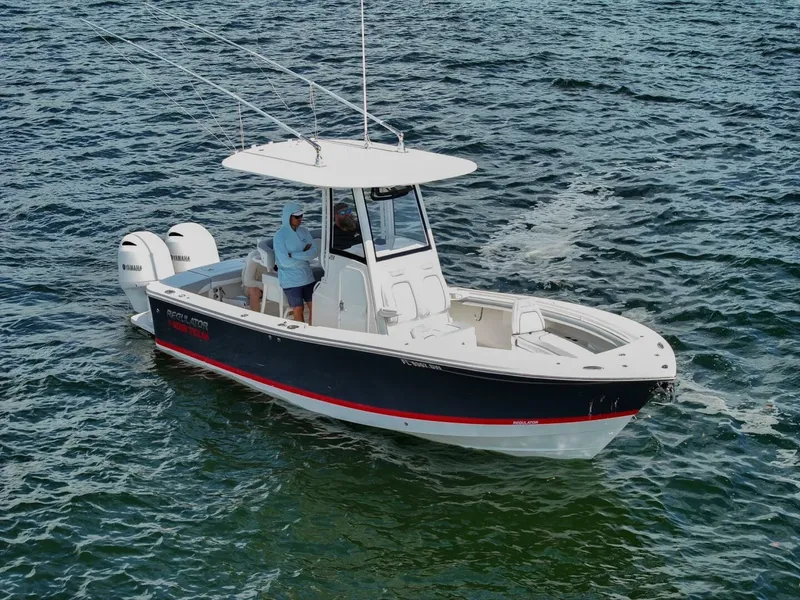 The Image of 2020 Regulator 23 boat on water, featuring dual outboard engines. - 1