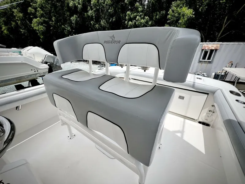 Slide: The Image of 2020 Regulator 23 boat seating with gray and white upholstery. - 14