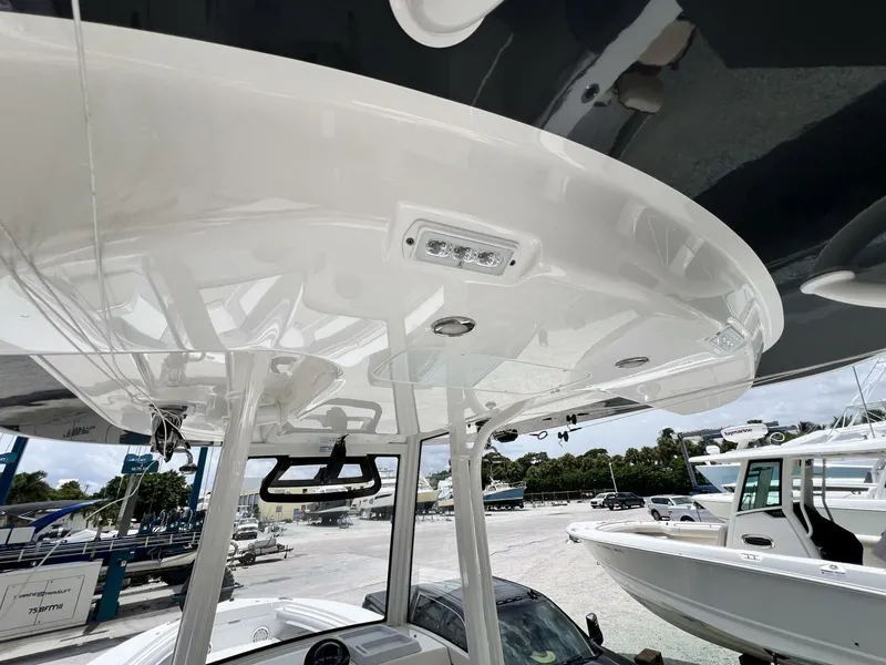 Slide: The Image of 2020 Regulator 23 boat with sleek white hardtop and modern design. - 16