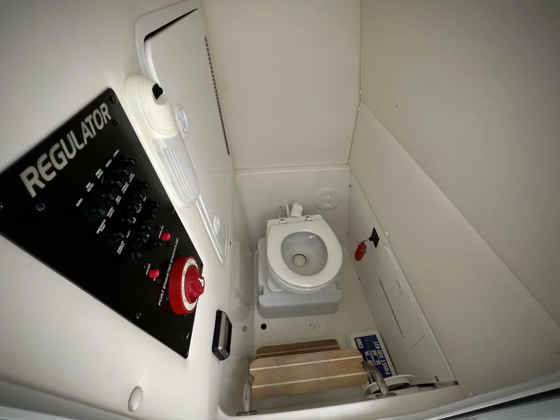 Slide: The Image of 2020 Regulator 23 boat interior with control panel and marine toilet. - 27