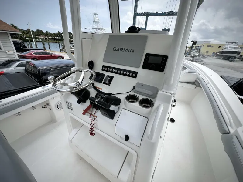 Slide: The Image of 2020 Regulator 23 boat console with Garmin navigation system and steering wheel. - 28