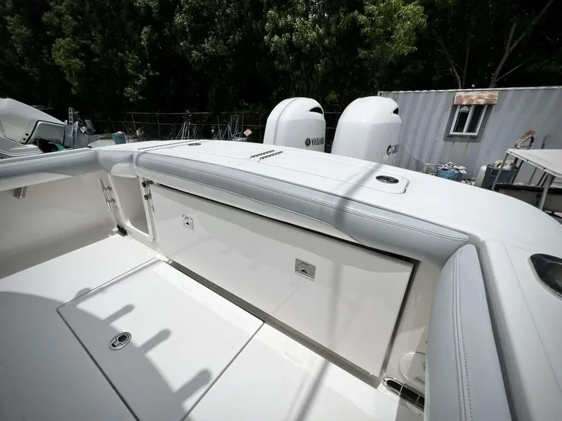 Slide: The Image of 2020 Regulator 23 boat with Yamaha engines, sleek white design, outdoor setting. - 31