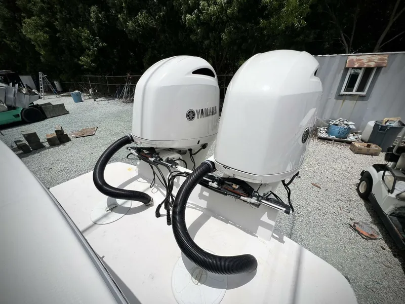 Slide: The Image of Twin Yamaha outboard engines on 2020 Regulator 23 boat, parked on gravel. - 32