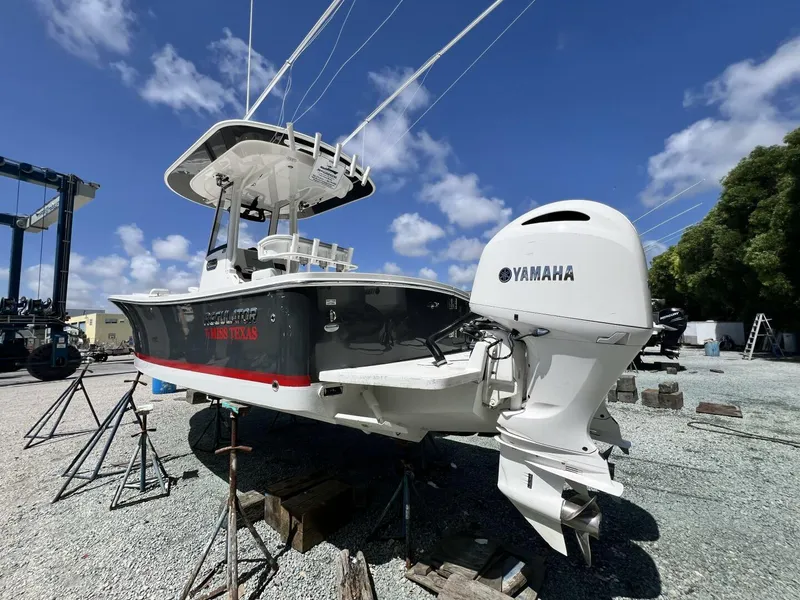 Slide: The Image of 2020 Regulator 23 boat with Yamaha engine on dry dock under blue sky. - 9