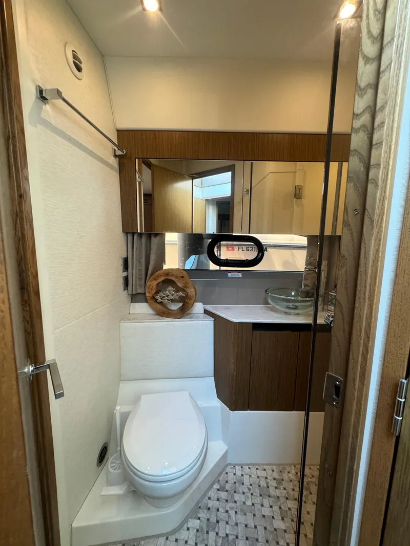 Slide: The Image of Luxurious 2017 Sea Ray Sundancer bathroom with modern fixtures and elegant wood accents. - 11