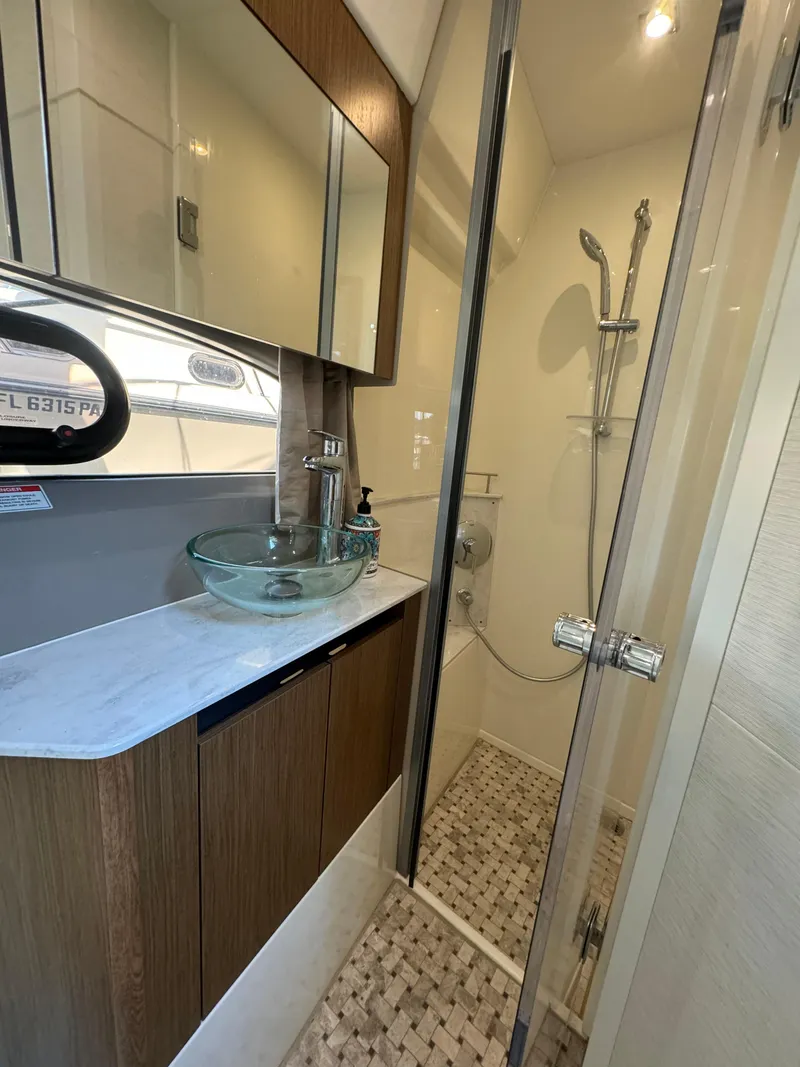Slide: The Image of Luxurious bathroom in 2017 Sea Ray Sundancer yacht with glass sink and modern shower. - 14