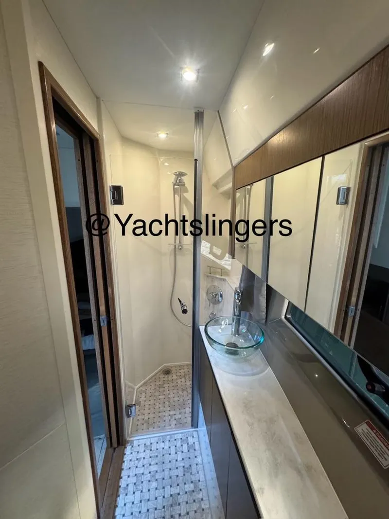 Slide: The Image of 2017 Sea Ray Sundancer yacht bathroom with modern fixtures and glass sink. - 18