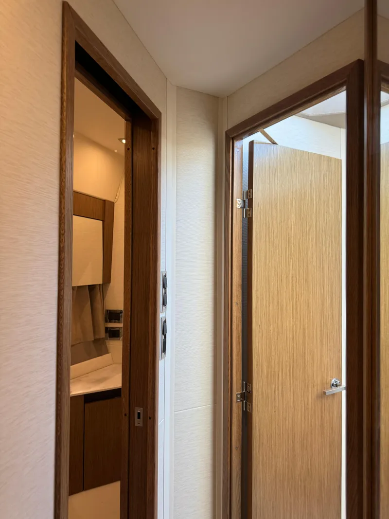 Slide: The Image of Interior view of 2017 Sea Ray Sundancer yacht, featuring wooden doors and modern design. - 25