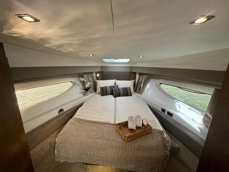 Slide: The Image of Luxurious 2017 Sea Ray Sundancer cabin interior with cozy bed and elegant decor. - 3