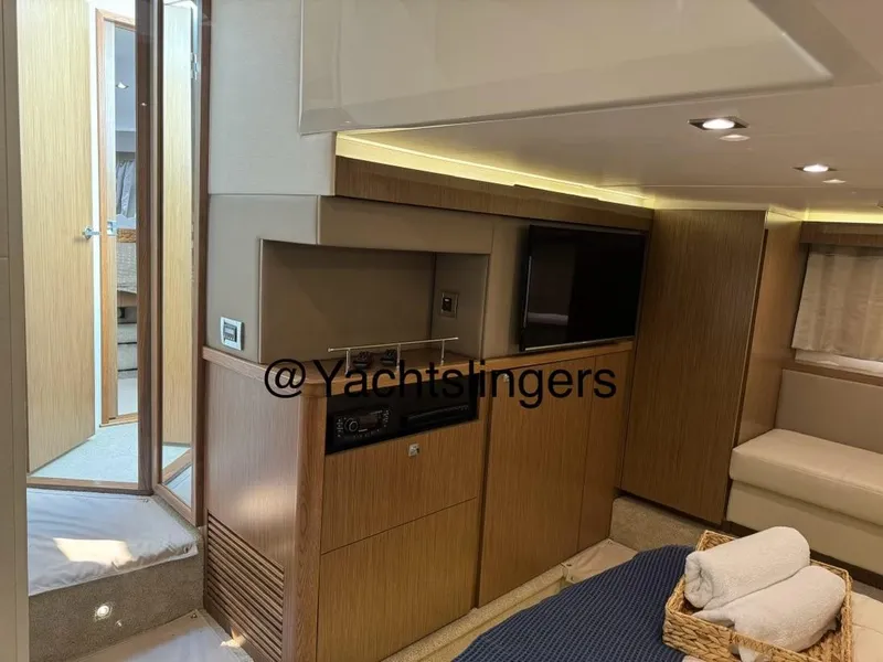 Slide: The Image of Interior of 2017 Sea Ray Sundancer yacht with modern wood finishes and cozy seating area. - 31