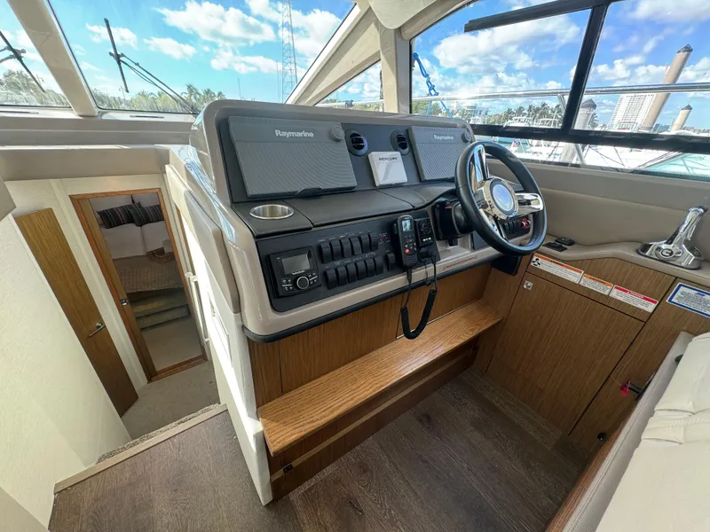 Slide: The Image of 2017 Sea Ray Sundancer helm with modern controls and navigation equipment. - 37