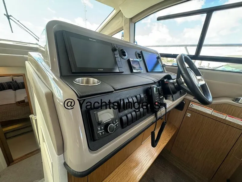 Slide: The Image of 2017 Sea Ray Sundancer helm with modern navigation equipment and steering wheel. - 42