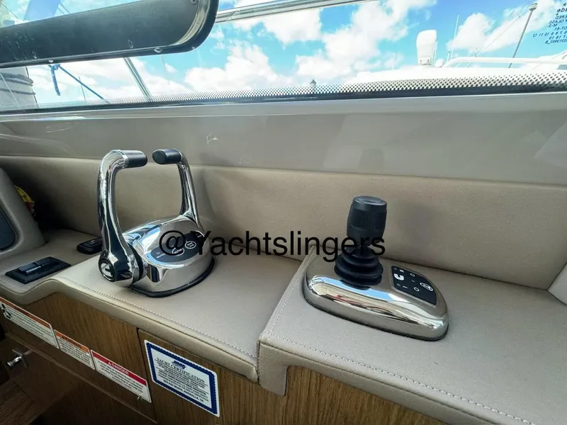 Slide: The Image of 2017 Sea Ray Sundancer helm controls with joystick and throttle, interior view. - 43