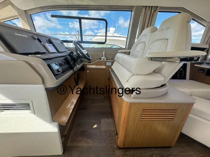 Slide: The Image of Interior of 2017 Sea Ray Sundancer yacht with luxurious seating and modern dashboard. - 46