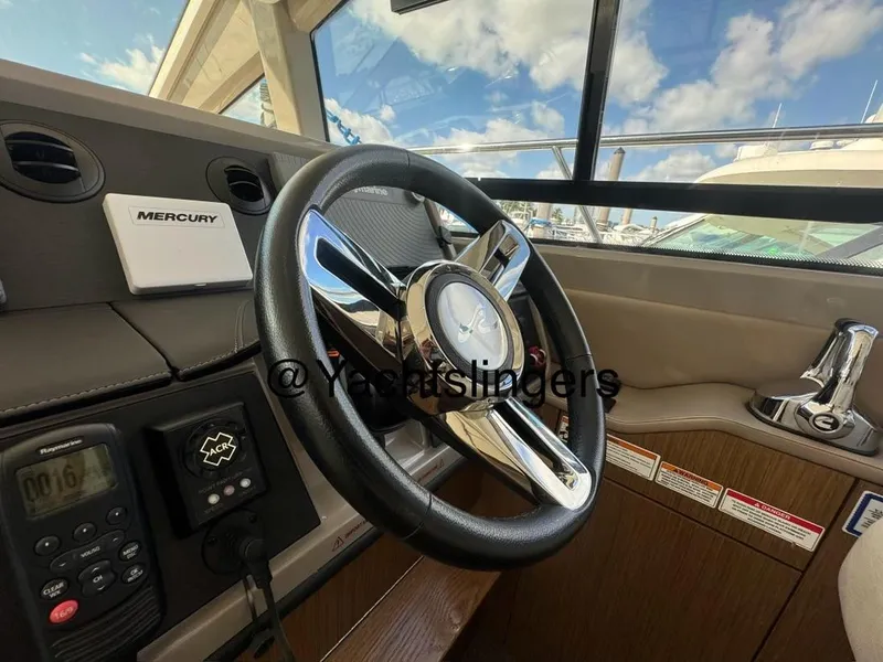 Slide: The Image of 2017 Sea Ray Sundancer helm with Mercury controls and modern steering wheel. - 47