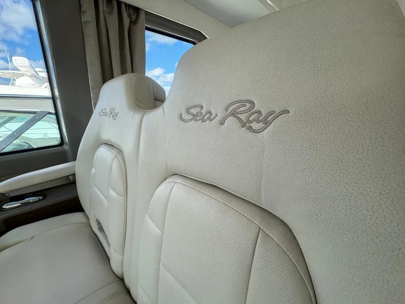 Slide: The Image of Luxurious interior seating of 2017 Sea Ray Sundancer yacht, featuring embroidered branding. - 48