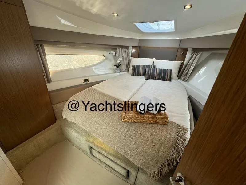 Slide: The Image of Luxurious 2017 Sea Ray Sundancer yacht cabin with cozy bed and elegant decor. - 5