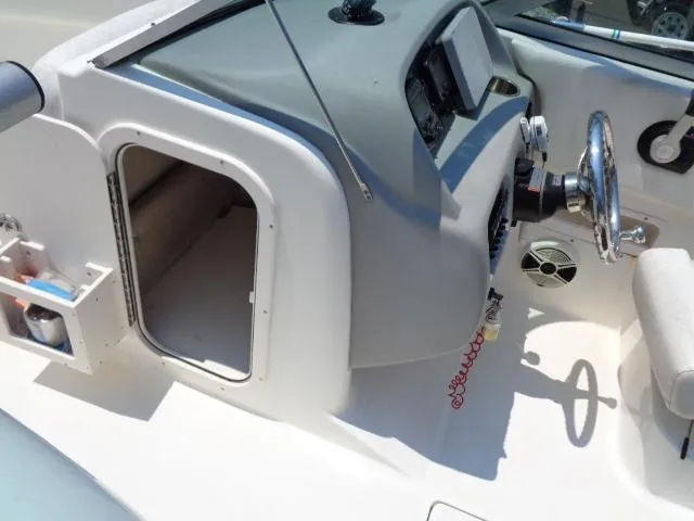 Slide: The Image of 2009 Robalo R227 Dual Console boat helm and storage compartment. - 19